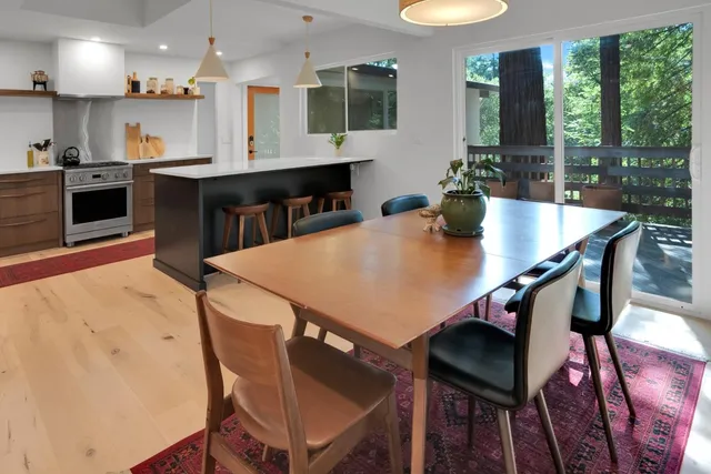a view of a dining room with furniture and a floor to ceiling window