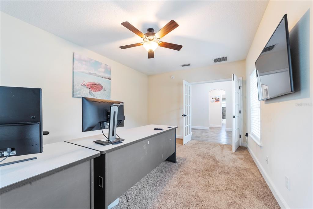 265 Pinehurst Pointe Drive St. Augustine, FL 32092 - Photo 12 of 66 a living room with stainless steel appliances kitchen island furniture and a flat screen tv