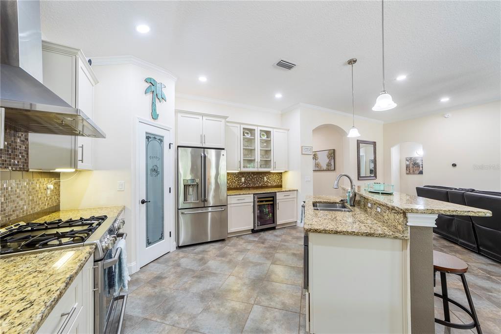 265 Pinehurst Pointe Drive St. Augustine, FL 32092 - Photo 15 of 66 a kitchen with refrigerator a stove and cabinets
