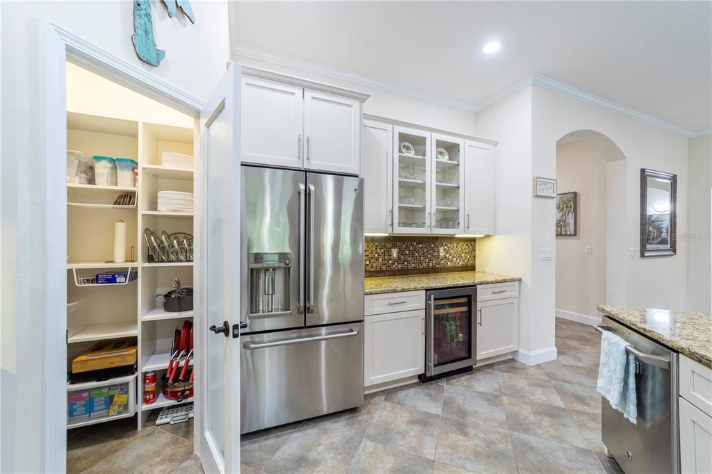 265 Pinehurst Pointe Drive St. Augustine, FL 32092 - Photo 16 of 66 a kitchen with stainless steel appliances a refrigerator sink and cabinets