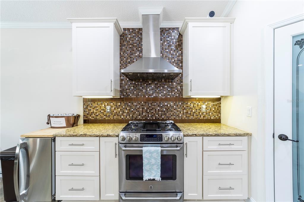 265 Pinehurst Pointe Drive St. Augustine, FL 32092 - Photo 17 of 66 a kitchen with stainless steel appliances white cabinets and a stove