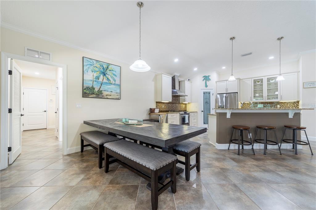 265 Pinehurst Pointe Drive St. Augustine, FL 32092 - Photo 21 of 66 a room with stainless steel appliances kitchen island a table chairs and a kitchen view