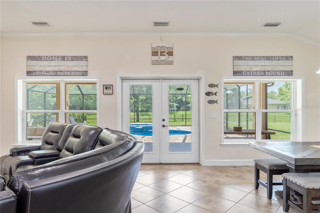 265 Pinehurst Pointe Drive St. Augustine, FL 32092 - Photo 26 of 66 a living room with furniture and large windows
