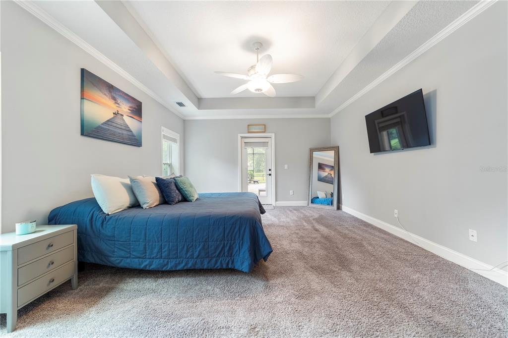 265 Pinehurst Pointe Drive St. Augustine, FL 32092 - Photo 28 of 66 a spacious bedroom with a bed and a flat screen tv