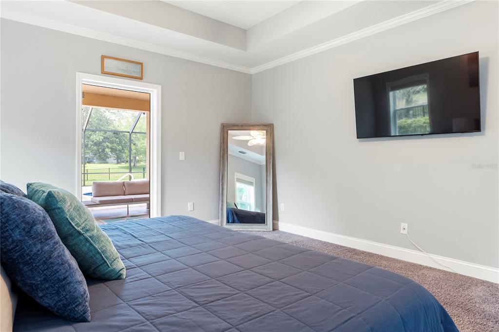 265 Pinehurst Pointe Drive St. Augustine, FL 32092 - Photo 29 of 66 a bedroom with a bed and a flat screen tv