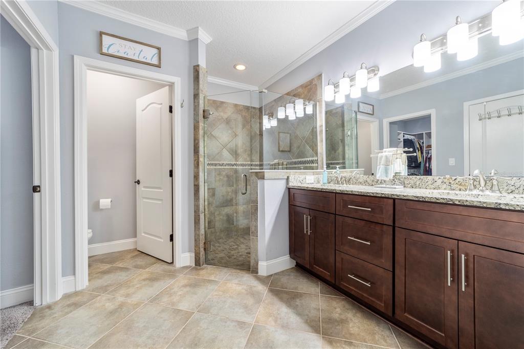 265 Pinehurst Pointe Drive St. Augustine, FL 32092 - Photo 35 of 66 a bathroom with a sink and a mirror
