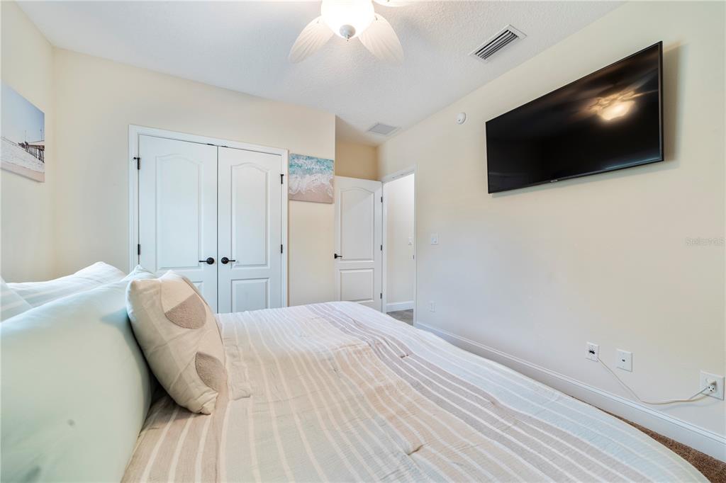 265 Pinehurst Pointe Drive St. Augustine, FL 32092 - Photo 39 of 66 a bedroom with a bed and a flat screen tv