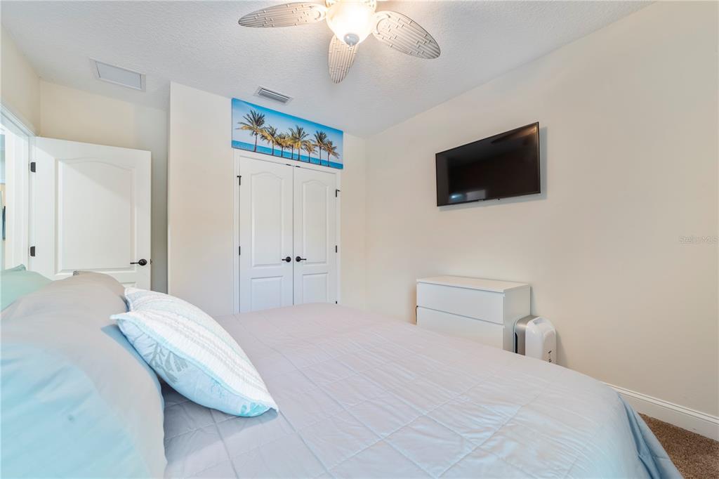 265 Pinehurst Pointe Drive St. Augustine, FL 32092 - Photo 42 of 66 a bedroom with a bed and a flat screen tv