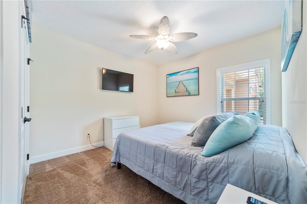 265 Pinehurst Pointe Drive St. Augustine, FL 32092 - Photo 44 of 66 a bedroom with a bed and a chandelier