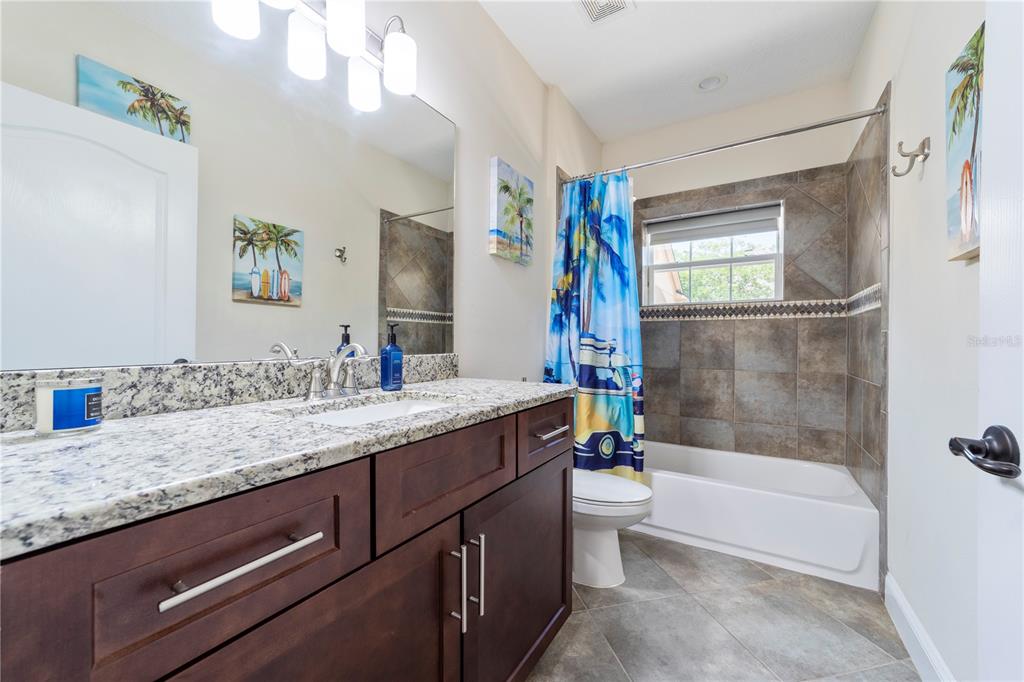 265 Pinehurst Pointe Drive St. Augustine, FL 32092 - Photo 46 of 66 a bathroom with a granite countertop sink a toilet and bathtub