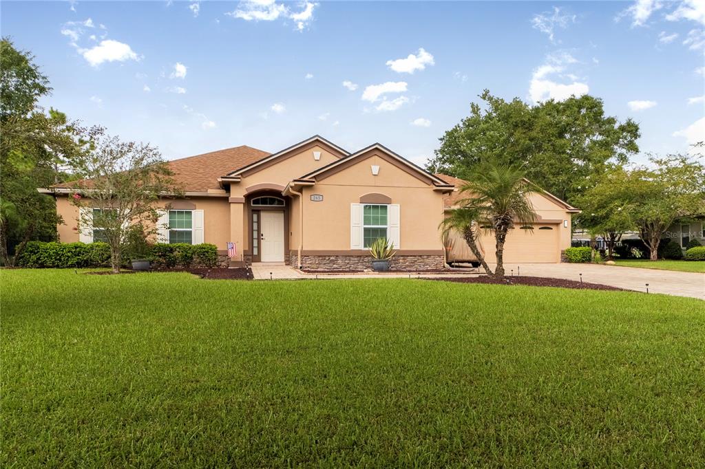 265 Pinehurst Pointe Drive St. Augustine, FL 32092 - Photo 63 of 66 a front view of a house with a garden and yard