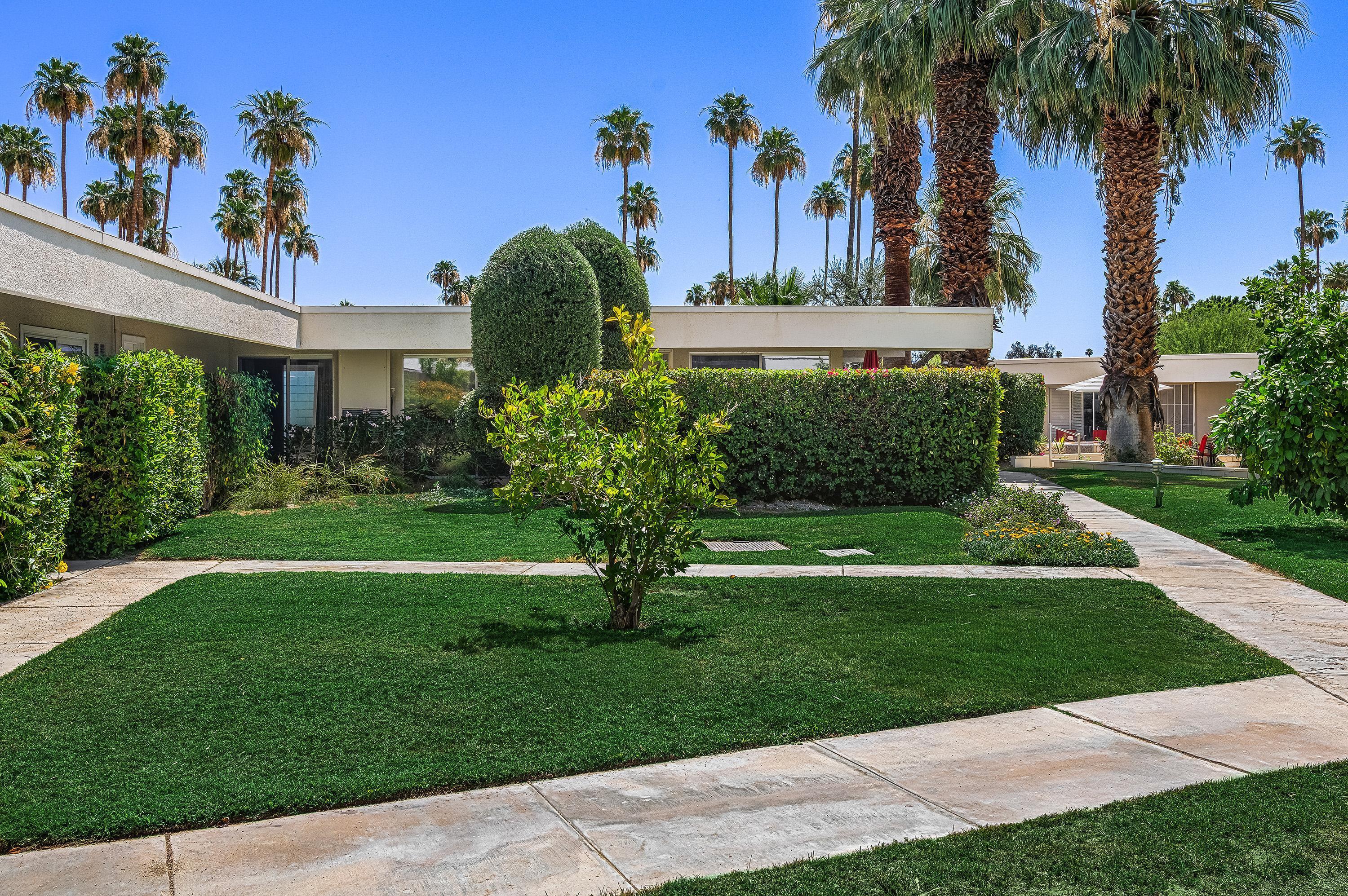 1855 Ramon Road, Unit 14 Palm Springs, CA 92264 - Photo 2 of 34 a front view of a house with a garden