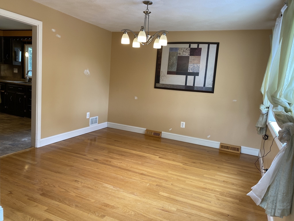 2 Travis Road Natick, MA 01760 - Photo 14 of 18 a view of an empty room with wooden floor and a window