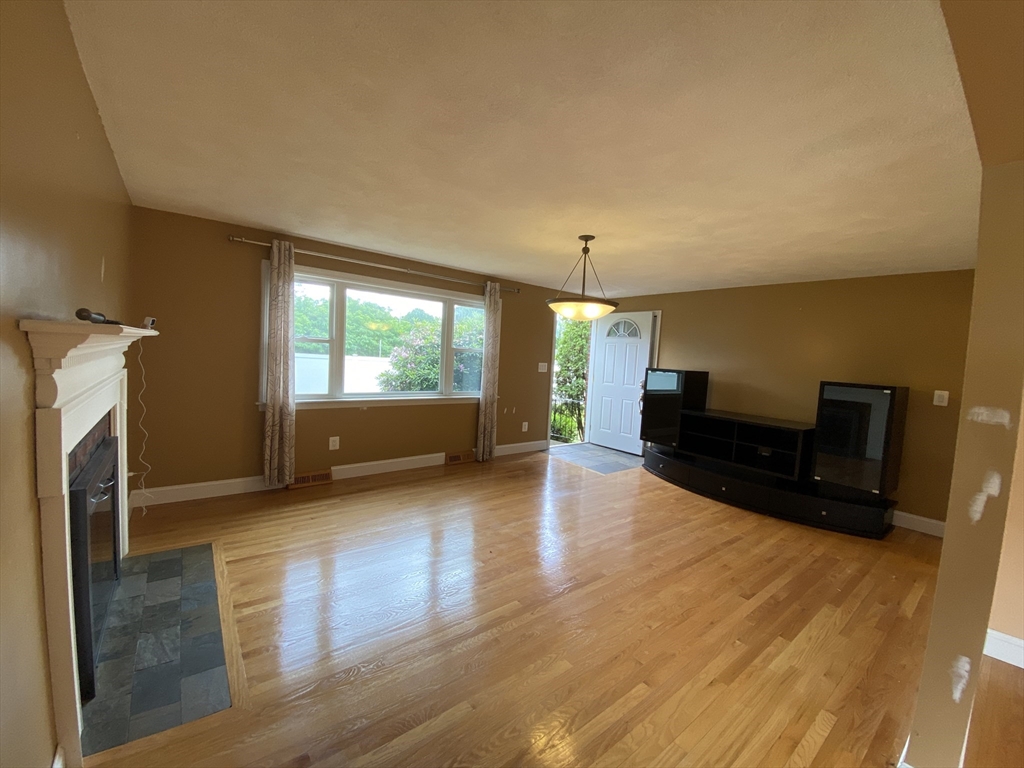 2 Travis Road Natick, MA 01760 - Photo 17 of 18 a living room with furniture and a fireplace