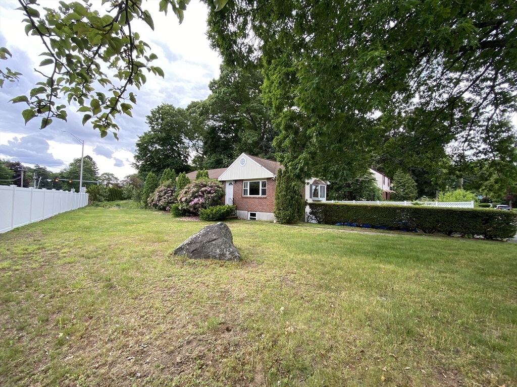 2 Travis Road Natick, MA 01760 - Photo 2 of 18 a house with green field in front of it