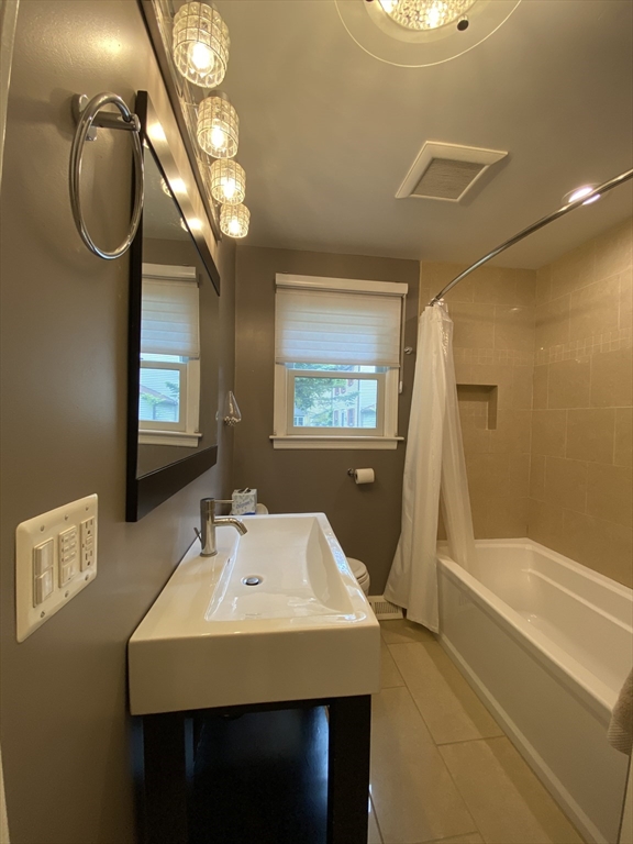 2 Travis Road Natick, MA 01760 - Photo 7 of 18 a bathroom with a sink a bathtub and a mirror