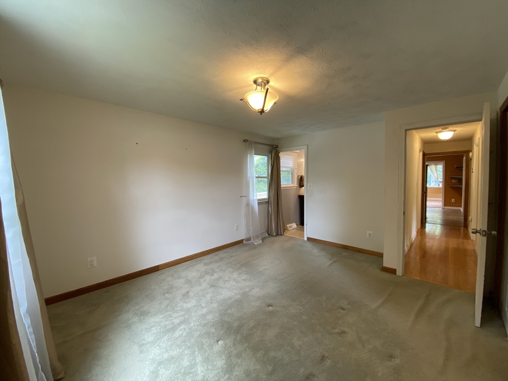 2 Travis Road Natick, MA 01760 - Photo 8 of 18 an empty room with chandelier fan and windows