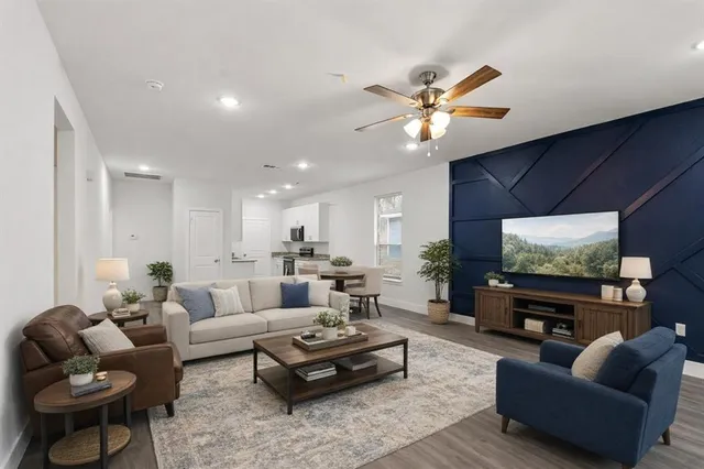 a living room with furniture and a flat screen tv