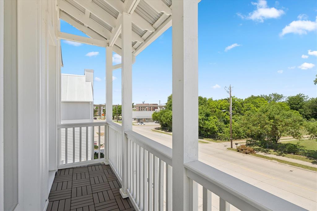 1362 East Crosby Road Carrollton, TX 75006 - Photo 5 of 22 Private balcony featuring dark wood-finish flooring, white shiplap siding, and white railings