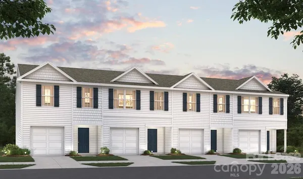 a front view of a residential apartment building with a yard