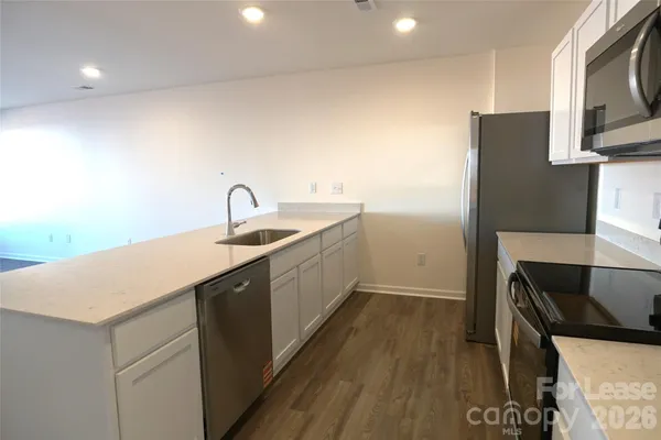 a kitchen with a sink and refrigerator