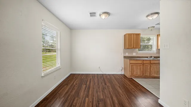 a view of kitchen with sink and wooden floor