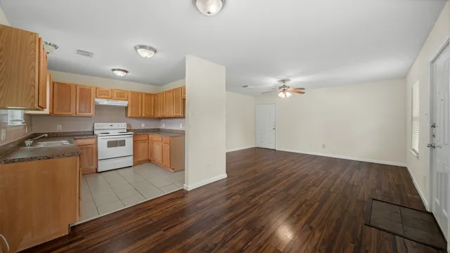 a kitchen with wooden floors and appliances
