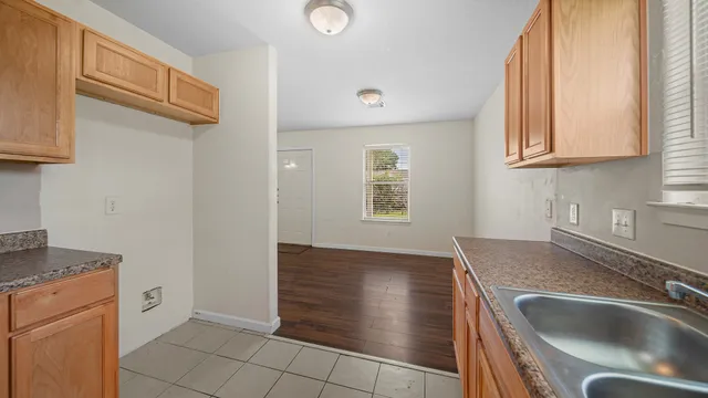 a kitchen with a sink and a stove top oven