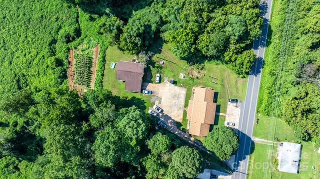 an aerial view of a house with a yard and plants