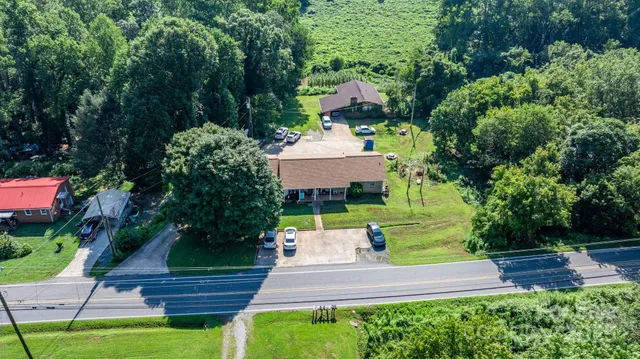 a front view of a house with a yard and fountain