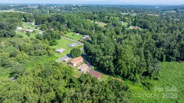 an aerial view of a houses with a yard