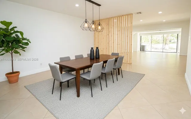 a view of a dining room with furniture and chandelier
