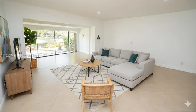 a living room with furniture and a large window