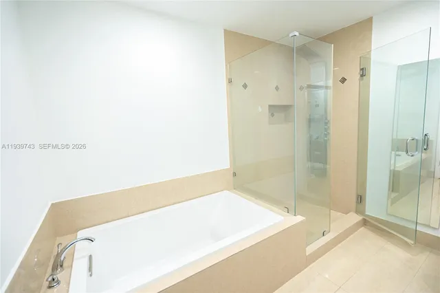 a bathroom with a tub and shower