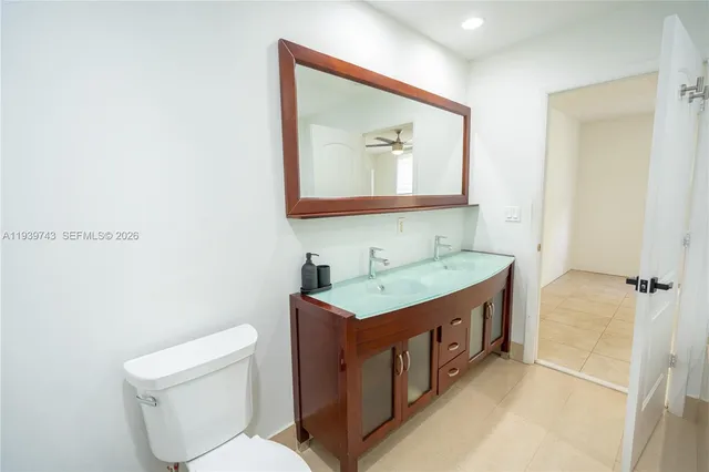 a bathroom with a toilet a sink and mirror