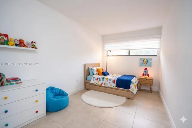 a living room with furniture and baby crib