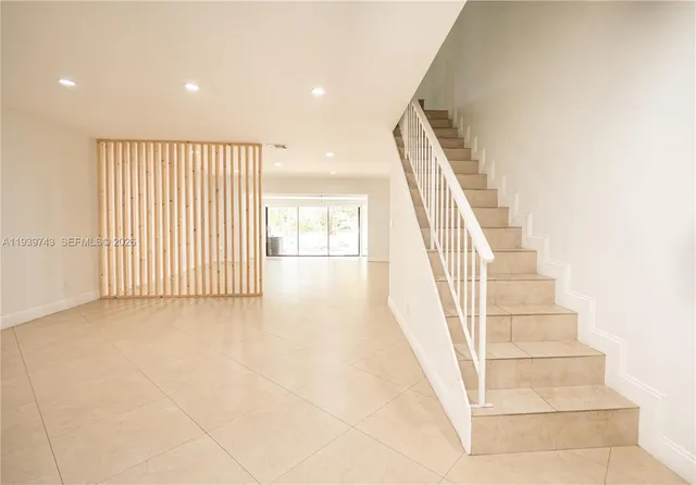 a view of staircase with white walls and windows