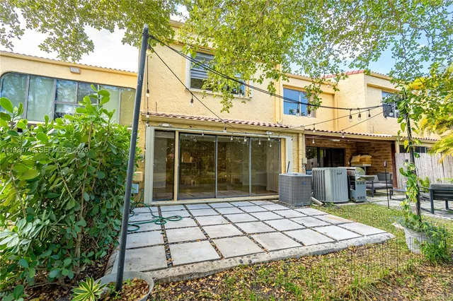 a view of a house with backyard sitting area and garden