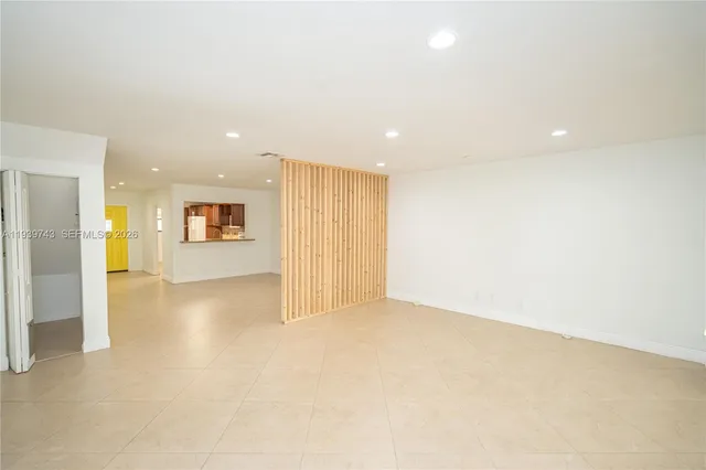 an empty room with a bathroom and a shower