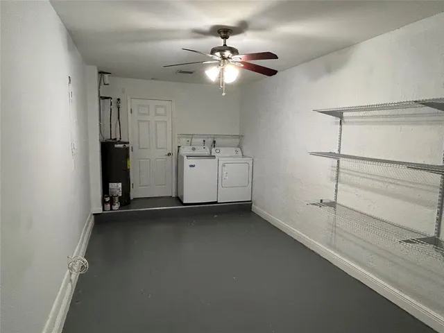 a view of an empty room with a ceiling fan