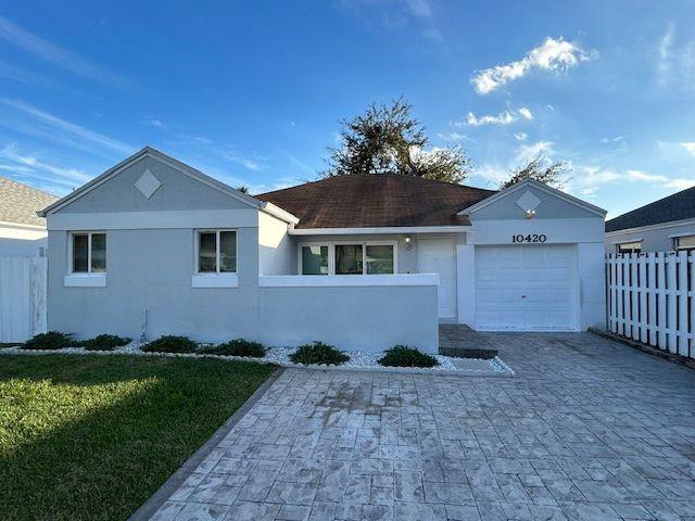 10420 Southwest 207th Street Cutler Bay, FL 33189 - Photo 2 of 12 a front view of a house with a yard