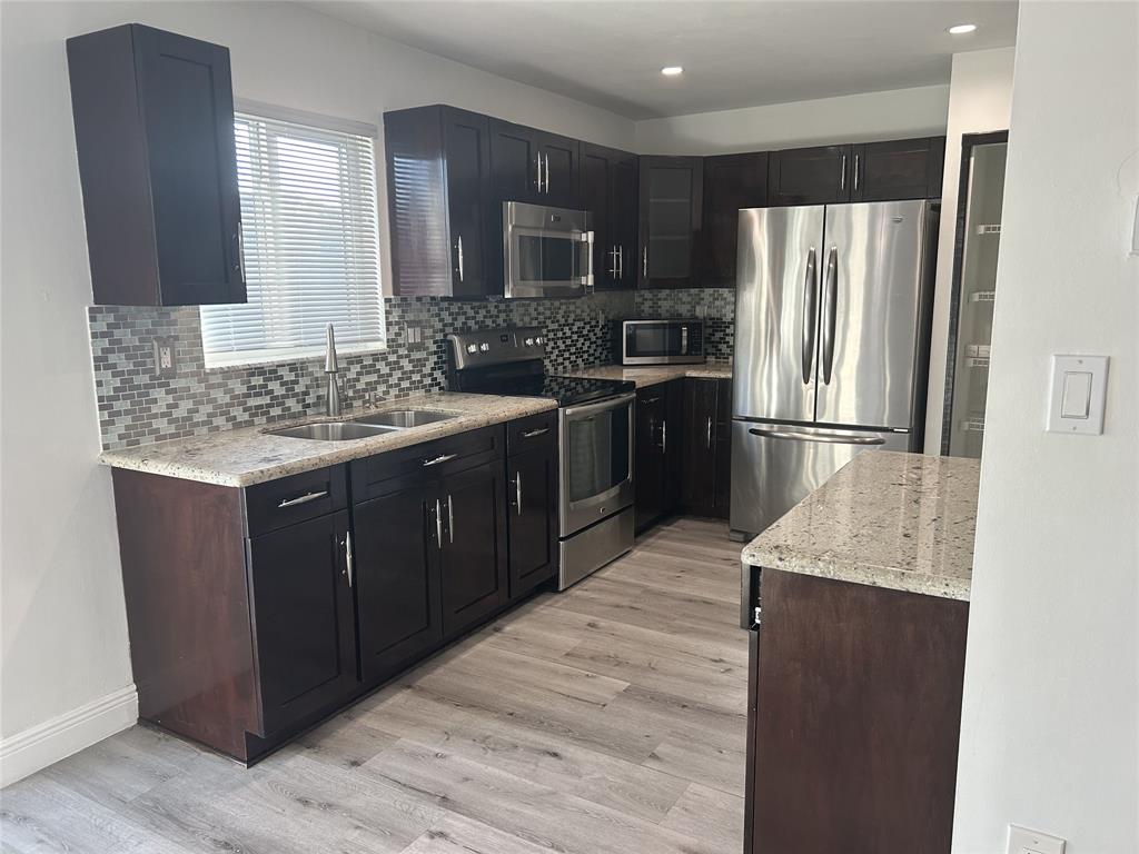 10420 Southwest 207th Street Cutler Bay, FL 33189 - Photo 4 of 12 a kitchen with a refrigerator stove and sink