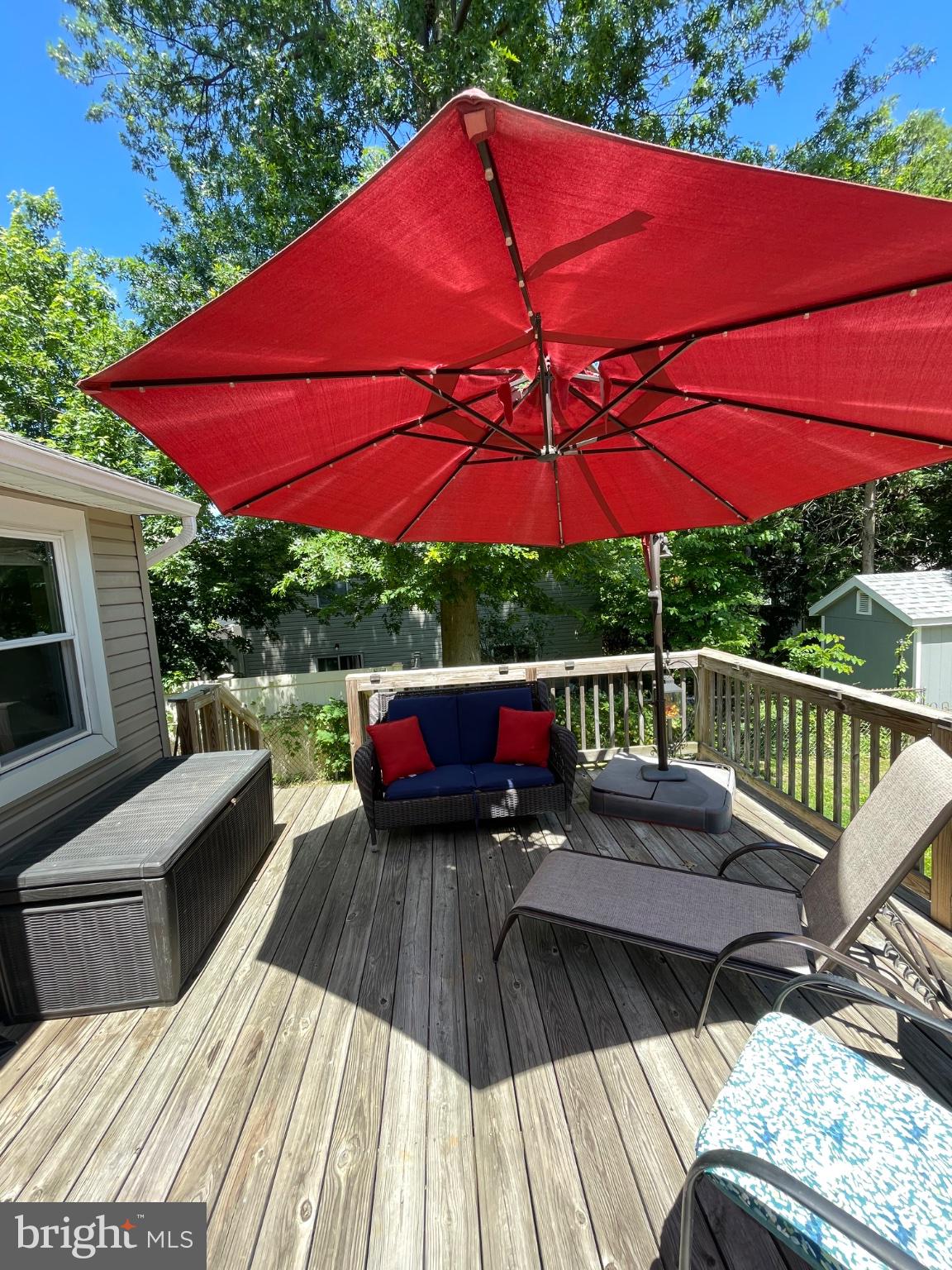 8129 Pine Road Philadelphia, PA 19111 - Photo 32 of 40 Sunny deck with vibrant red umbrella.