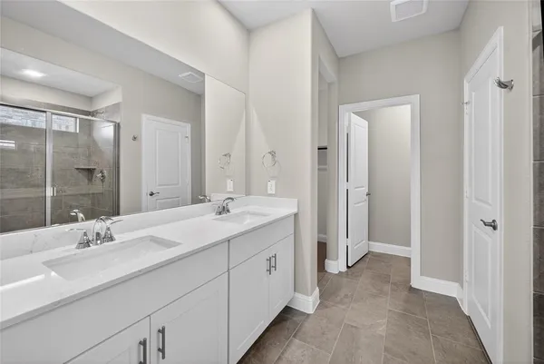 a spacious bathroom with a double vanity sink mirror and double