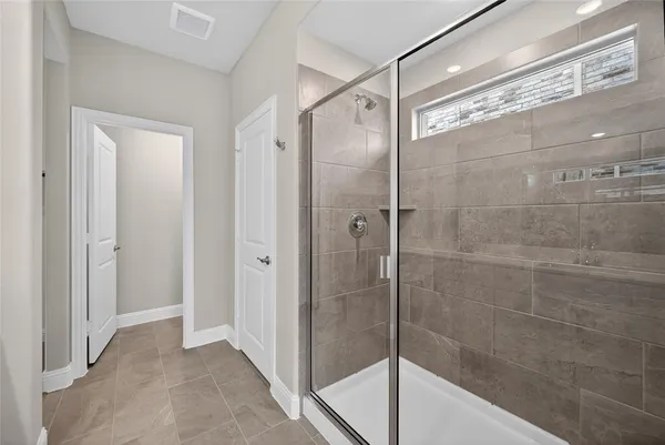 a bathroom with a glass shower door