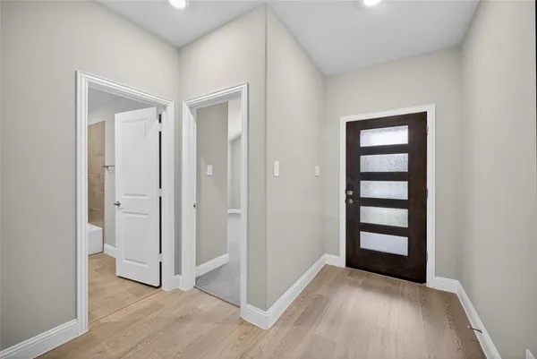 an empty room with windows closet and bathroom
