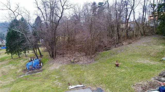 a aerial view of a houses with yard