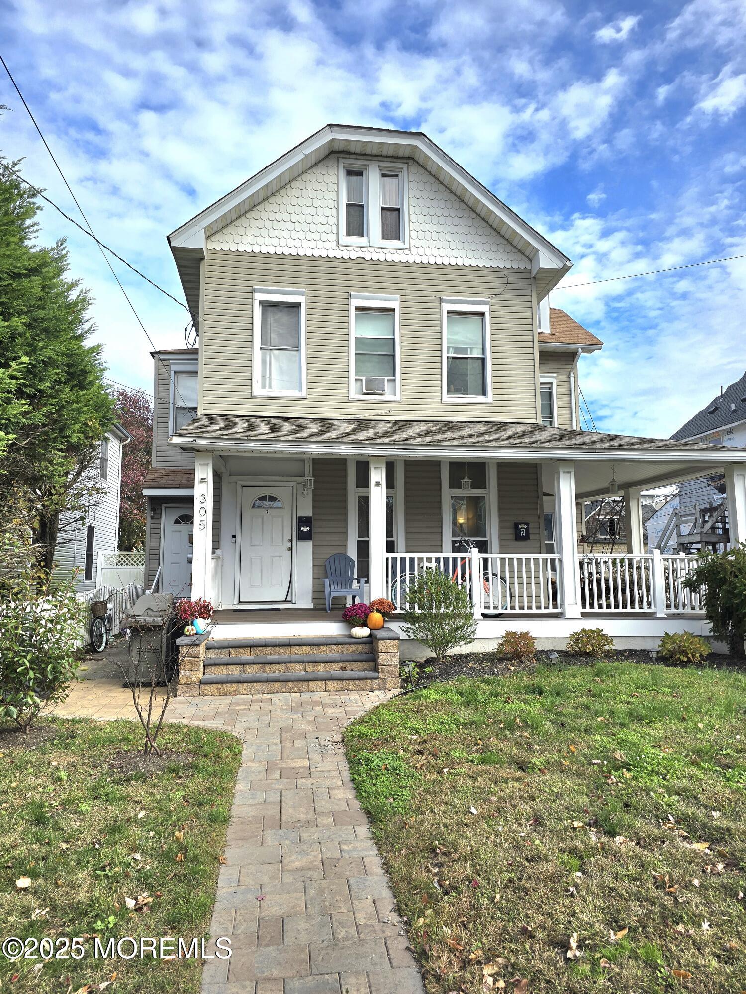 305 3rd Avenue, Unit 1 Asbury Park, NJ 07712 - Photo 11 of 13 a front view of a house with a yard