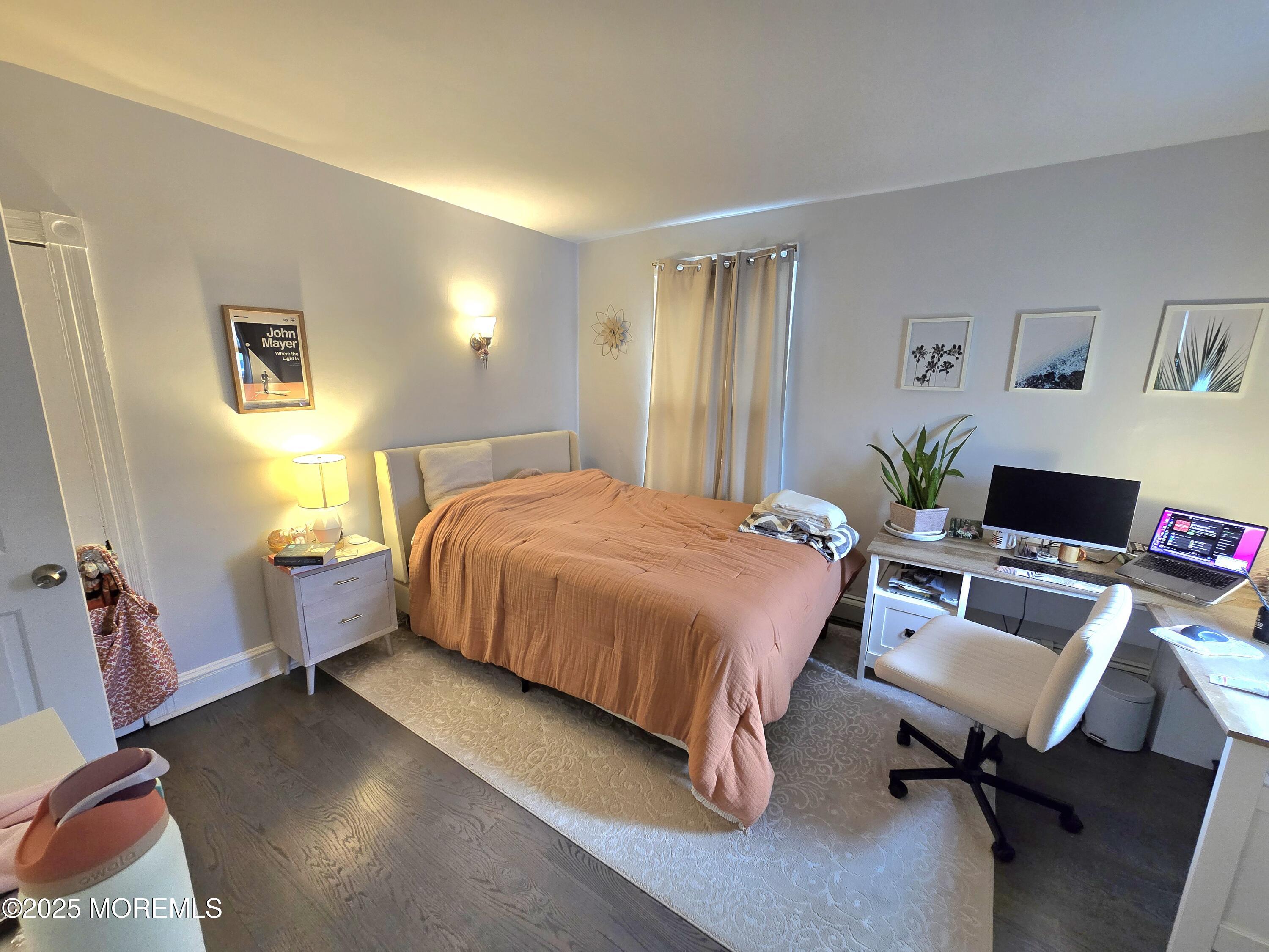 305 3rd Avenue, Unit 1 Asbury Park, NJ 07712 - Photo 8 of 13 a spacious bedroom with a bed and furniture