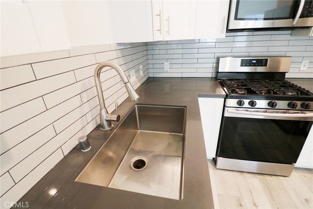 14254 Erwin Street Van Nuys, CA 91401 - Photo 8 of 18 a kitchen with a sink and a stove